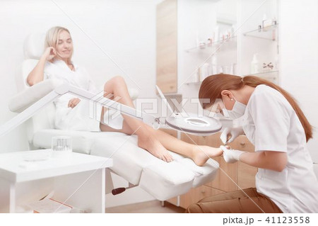 Podiatrist making procedure for client foot with special equipme Podiatrist making procedure for client foot with special equipme 41123558