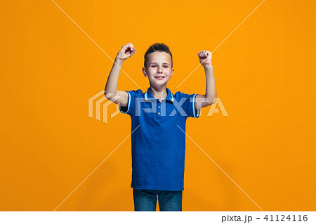 Happy success teen boy celebrating being a winner. Dynamic energetic image of female model Happy success teen boy celebrating being a winner. Dynamic energetic image of female model 41124116