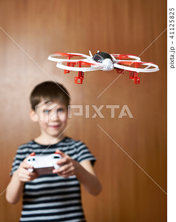 Happy little boy drives toy quadcopter drone 41125825