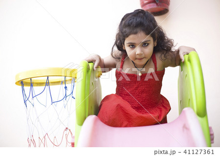 Girl with slide and basketball hoop 41127361