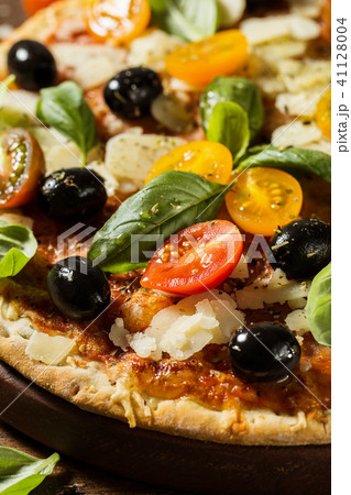 Traditional italian pizza on wooden table Traditional italian pizza on wooden table 41128004