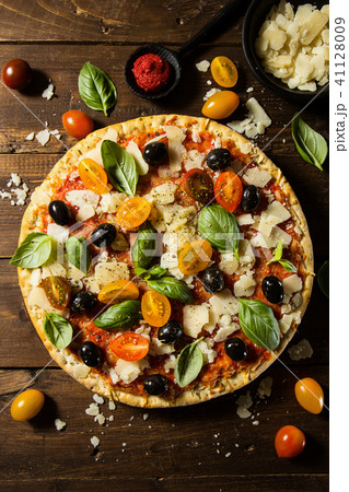 Traditional italian pizza on wooden table Traditional italian pizza on wooden table 41128009