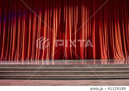 Red curtains and wooden stage. 41129189