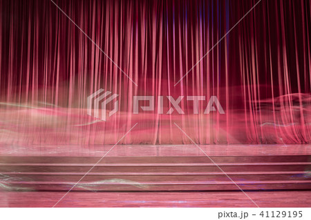 Old red curtains on stage. 41129195