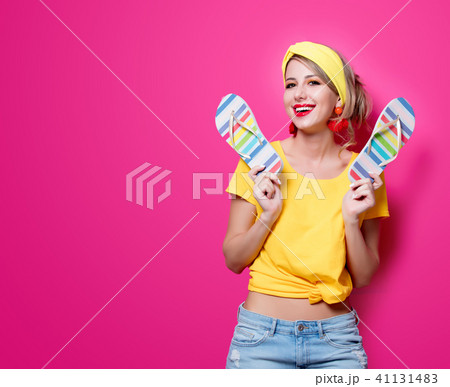 girl in yellow clothes with vacation flip flops 41131483