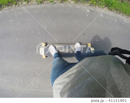 Riding a longboard in the first person. Riding a longboard in the first person. 41131901