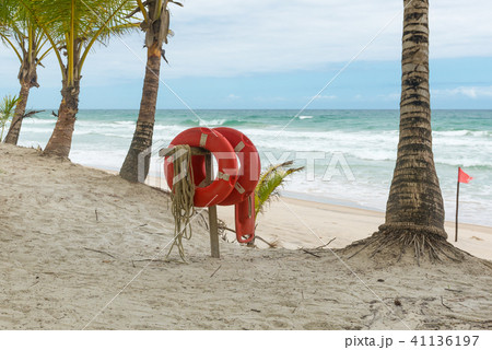 Red life buoy with rope and a flag Red life buoy with rope and a flag 41136197
