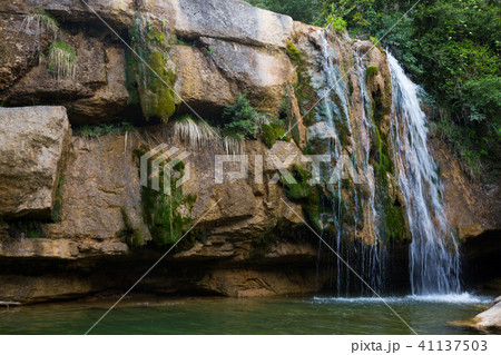 Pure mountain creek with green water 41137503