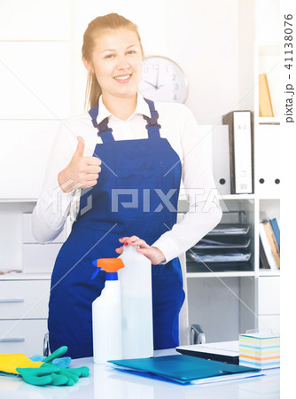 Female office cleaner is satisfied after cleaning Female office cleaner is satisfied after cleaning 41138076