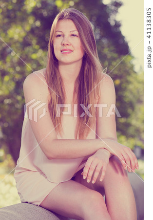 Woman 25-29 years old is sitting and having a rest on the bench Woman 25-29 years old is sitting and having a rest on the bench 41138305
