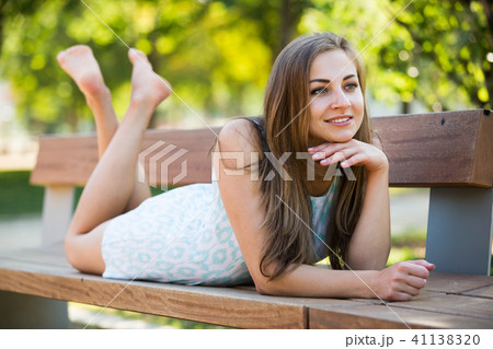portrait of smiling adult girl outside in park 41138320