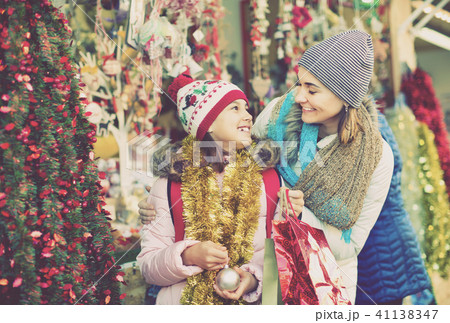 Female customers staring at counter of Christmas market Female customers staring at counter of Christmas market 41138347