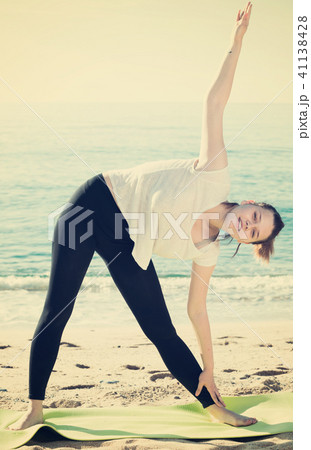 Fitness woman in white T-shirt is practicing set of stretching exercises Fitness woman in white T-shirt is practicing set of stretching exercises 41138428