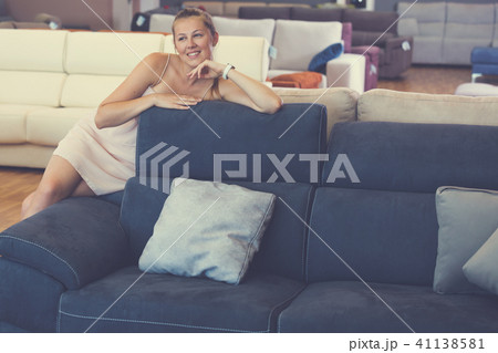 woman buyer sitting on sofa with pillow woman buyer sitting on sofa with pillow 41138581