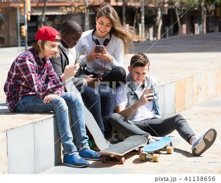 Laughing friends with smartphones in spring day 41138656