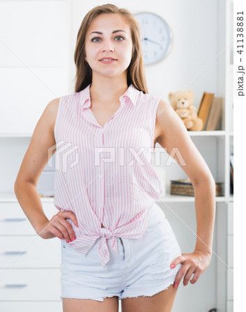 Smiling girl standing at home Smiling girl standing at home 41138881