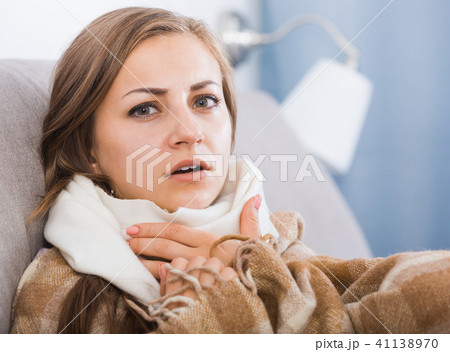 Sick girl with scarf on neck 41138970