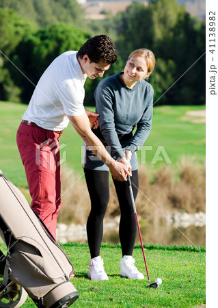 Golf trainer teaches a woman game Golf trainer teaches a woman game 41138982