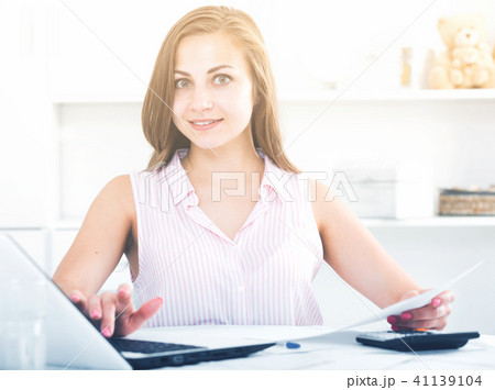 Young woman working on her finances Young woman working on her finances 41139104