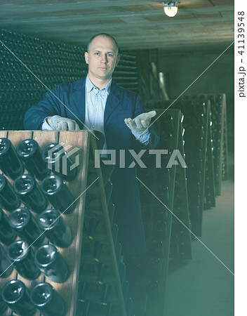 Winemaker checking bottles with wine Winemaker checking bottles with wine 41139548