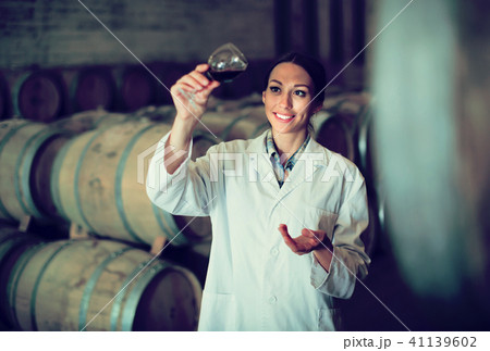 woman with glass of wine in cellar. woman with glass of wine in cellar. 41139602