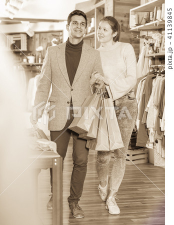 Young woman and man are walking satisfied with packadge after sh Young woman and man are walking satisfied with packadge after sh 41139845