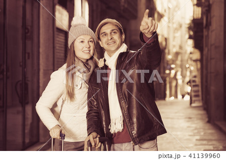 Couple at the historical streets pointing finger Couple at the historical streets pointing finger 41139960