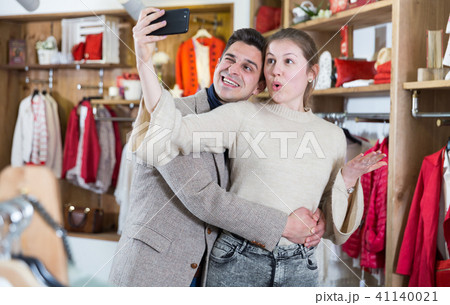 Couple is satisfied shopping and taking selfie Couple is satisfied shopping and taking selfie 41140021
