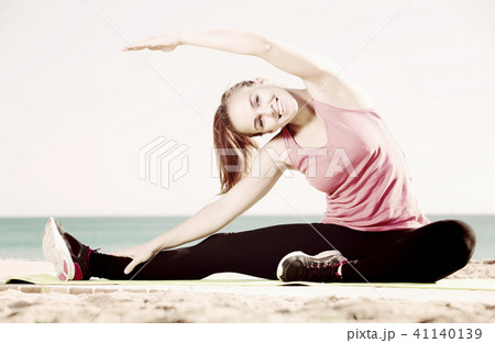 Happy young woman in track-suit active training 41140139