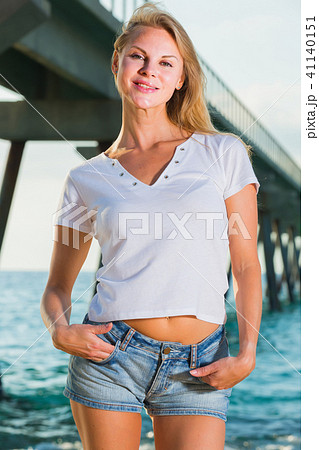 Elegant woman is resting on the rocks in her free time Elegant woman is resting on the rocks in her free time 41140151