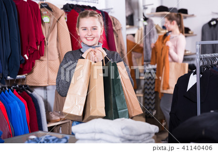Girl with shopping bags in clothes shop with mother Girl with shopping bags in clothes shop with mother 41140406