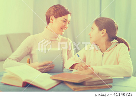 Mother and daughter doing school homework Mother and daughter doing school homework 41140725