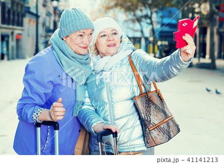Senior females travelers taking selfie Senior females travelers taking selfie 41141213