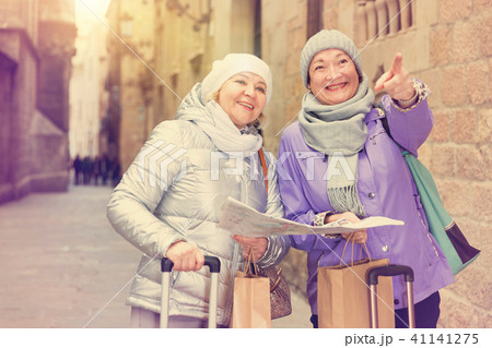 Senior females traveling with city map Senior females traveling with city map 41141275