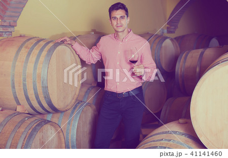 attractive man posing in winery cellar attractive man posing in winery cellar 41141460