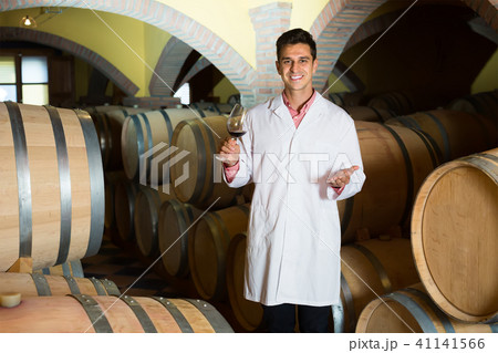 Man checking ageing process of red wine 41141566