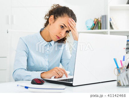 Portrait of unhappy businesswoman working in office 41142468