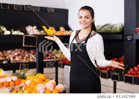 Woman assistant displaying fruits of grocery shop Woman assistant displaying fruits of grocery shop 41142566
