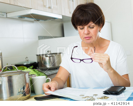 sad woman paying bills sad woman paying bills 41142914