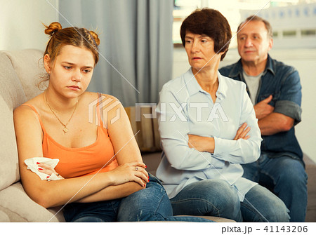 Mom and dad are supporting a sad daughter on sofa Mom and dad are supporting a sad daughter on sofa 41143206