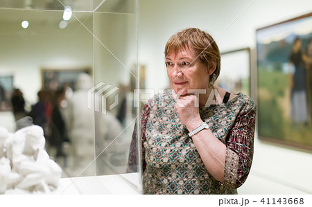 Woman visiting museum and enjoying sculture 41143668