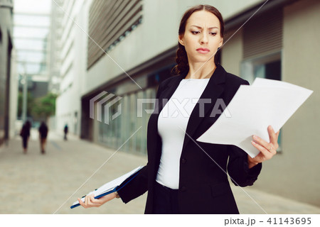 Serious woman is dissatisfied of the results of the financial report 41143695
