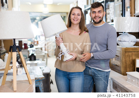 Girl with boyfriend in search of table lamp Girl with boyfriend in search of table lamp 41143758