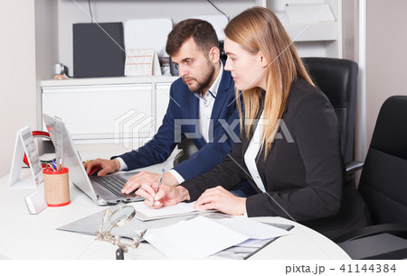 Portrait of adult salespeople working on laptop Portrait of adult salespeople working on laptop 41144384