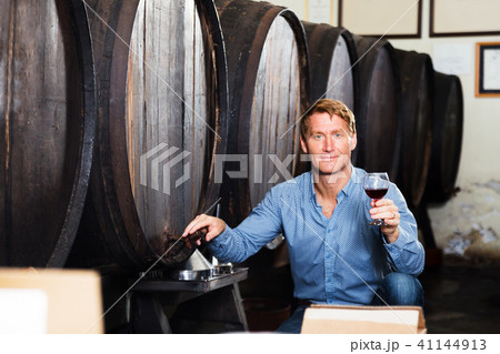 Man sommelier in wine cellar Man sommelier in wine cellar 41144913