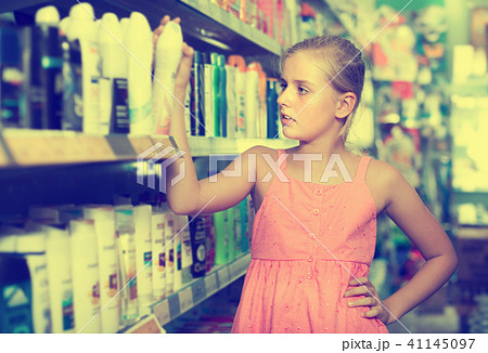 Young teenager girl choosing new deodorant 41145097