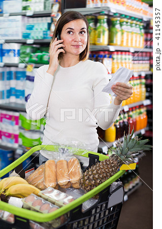 Happy female talking on phone about shopping Happy female talking on phone about shopping 41145357