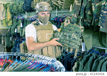 Male customer try on ammunition with rifle Male customer try on ammunition with rifle 41145416