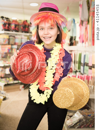 Girl looking for funny hats in store 41145458