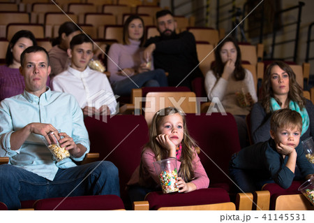 People eating popcorn in the cinema People eating popcorn in the cinema 41145531